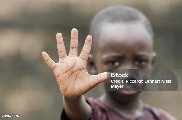 African Child Says Stop To Racism And To War Stock Photo - Download Image Now - Africa, Child, Poverty