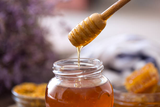 istock dripping sweet fresh honey from wooden dipper 649676030