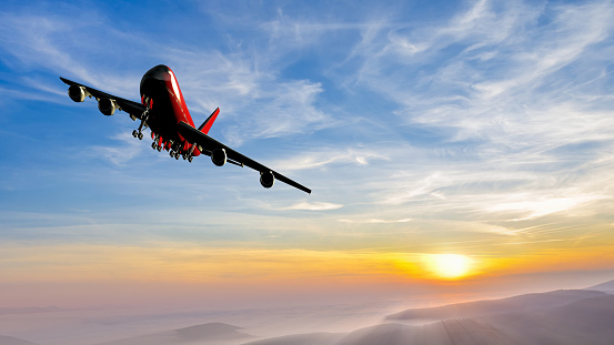 Jet plane is maneuvering for landing in a spectacular sunset sky