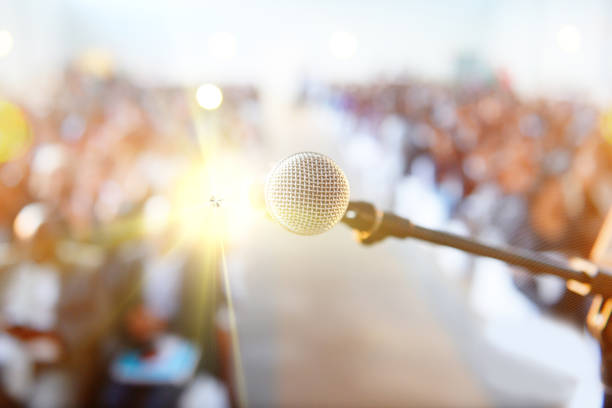 istock Guests wait for speaker to speak into the microphone 649677358