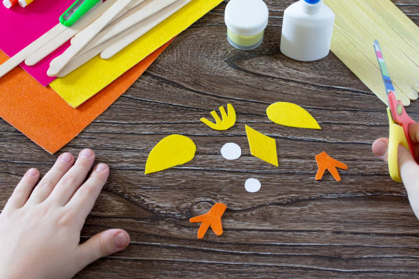 istock The child cuts out parts giftware. Children's Easter gift toy chicken and Easter bunny. Hand-made. The project of children's creativity, needlework, crafts for children. 649684708