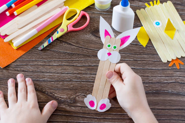 istock Children's easter gift from wooden chopsticks toy chicken and Easter bunny. Hand-made. The project of children's creativity, needlework, crafts for children. 649684752