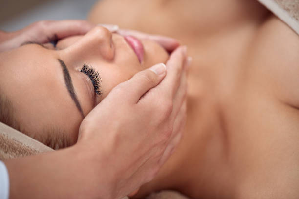 Skin and body care. Close-up of a young woman getting spa treatment at beauty salon. spa face massage. facial beauty treatment. spa salon. women facial mask mud cucumber stock pictures, royalty-free photos & images