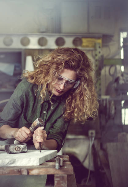 istock Female Stonecutter Carving the Stone 649692112