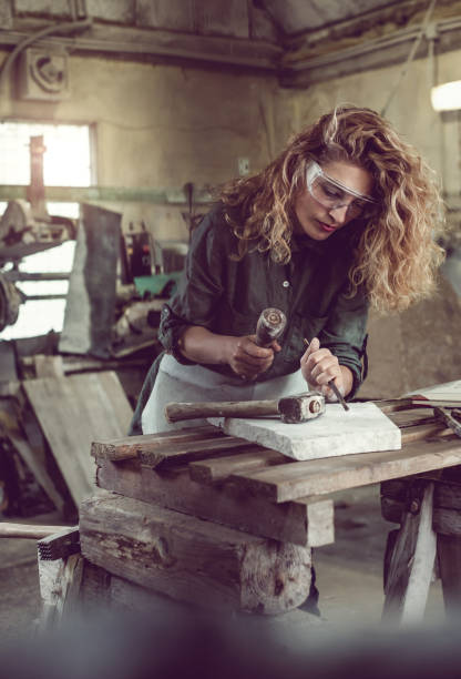 istock Female Stonecutter Carving the Stone 649692208