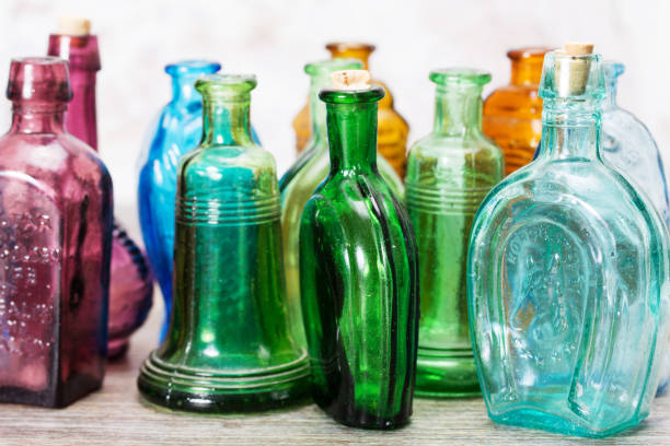 istock Coloured glass bottles on a rustic background 649692860