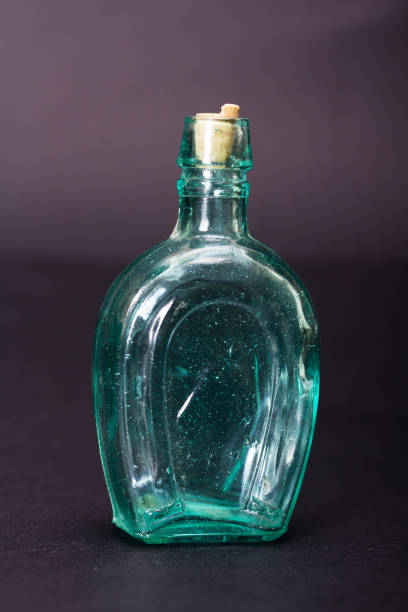 istock Old colourful bottles against a dark background 649692894