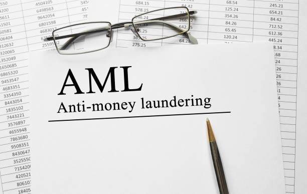 istock Paper with Anti-money laundering AML on a table 649695760