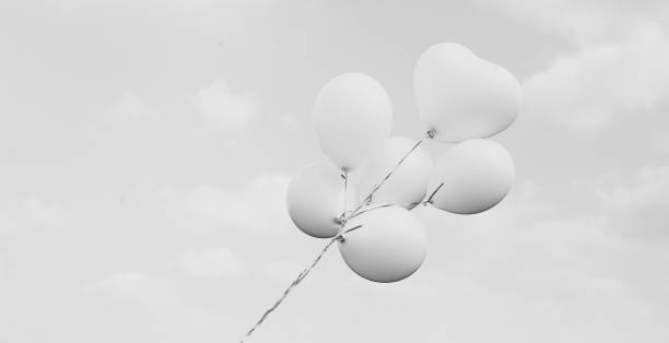 istock white balloons on blue sky background 649696278