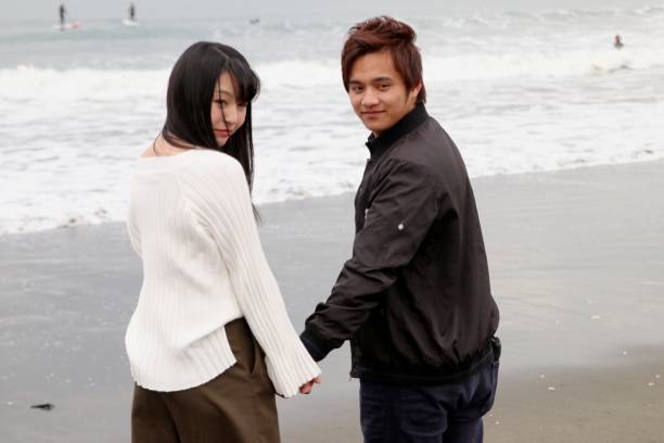 istock HIgh School Student Couple Standing at Beach 649699208
