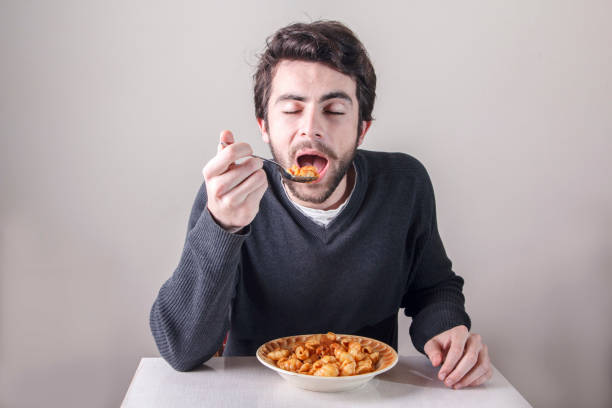 istock Hungry man eating food 649699410