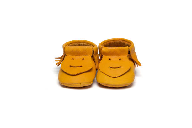 istock Childs yellow booties on a white background 649700868