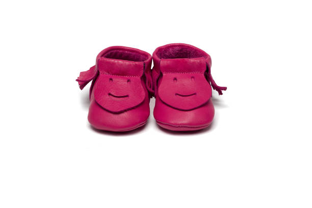 istock Childs dark pink booties on a white background 649700874