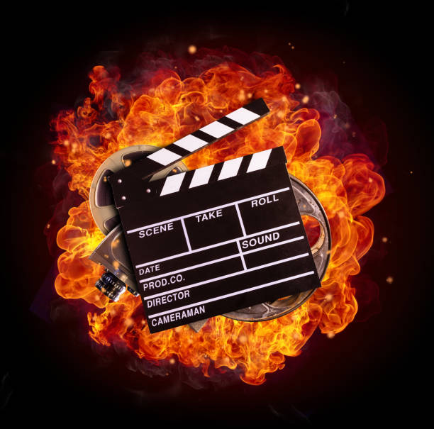 istock Film equipment in fire, isolated on black background 649704496