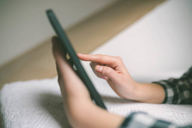 istock Beautiful girl is using a digital tablet 649708466