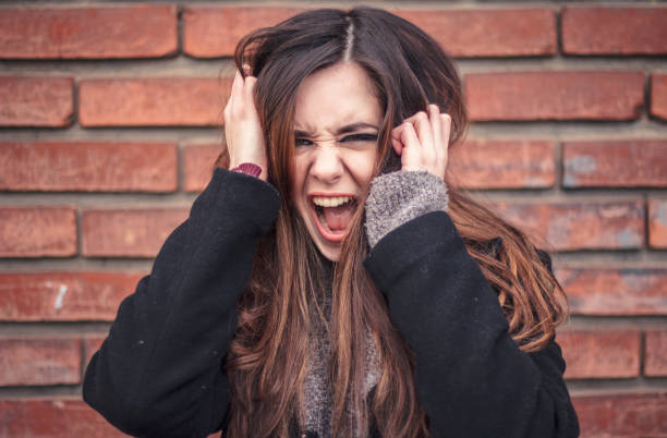istock Angry young woman screaming 649714170