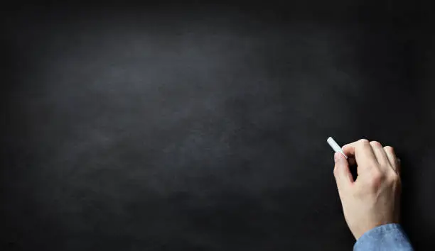 Photo of Blackboard or chalkboard with hand writing in chalk