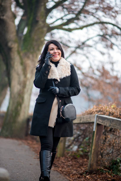 istock Beautiful woman talking on the phone 649726848