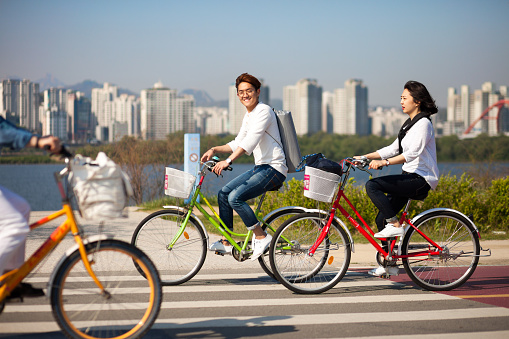 SEOUL, KOREA - APRIL 24, 2015: People cycling at a racreation park zone on the bank of Hangang river in Seoul, Korea