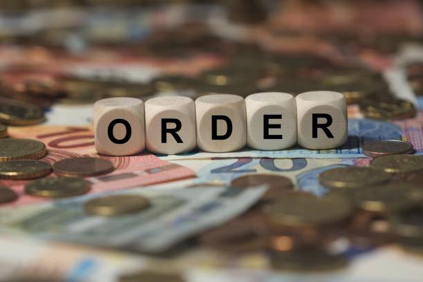 istock order - cube with letters, money sector terms - sign with wooden cubes 649729804