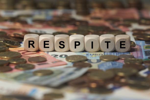 istock respite - cube with letters, money sector terms - sign with wooden cubes 649730426
