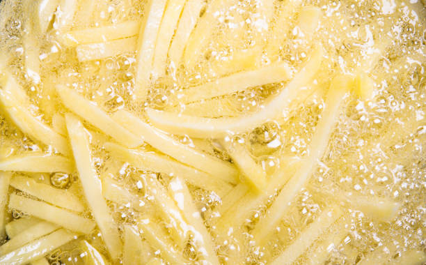 french fries in hot oil. stock photo