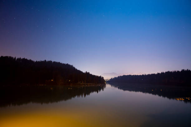istock Scenic view of river against star field at night 649734042