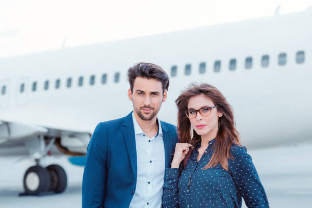 istock Business colleagues standing in front of airplane. 649734254