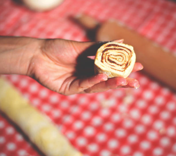 istock Cinnamon roll in woman hand 649735348