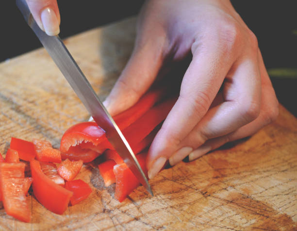 istock Female slicing pepper for salad. Close up chef cutting vegetables. 649735728