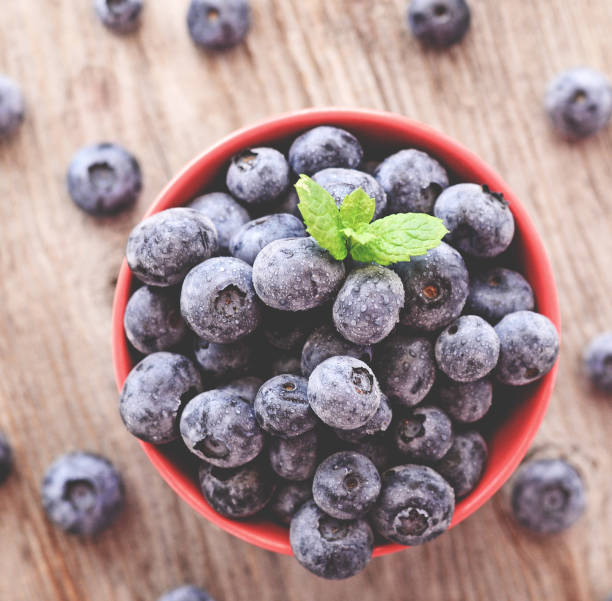 istock Fresh blueberry on wooden background 649735862