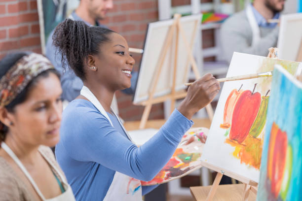 istock Beautiful women paint in art class 649736042