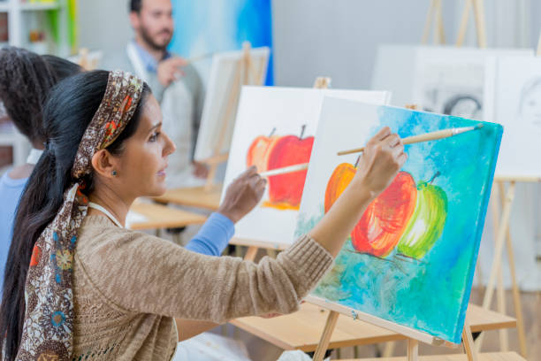 istock Mature woman participates in art class 649736060