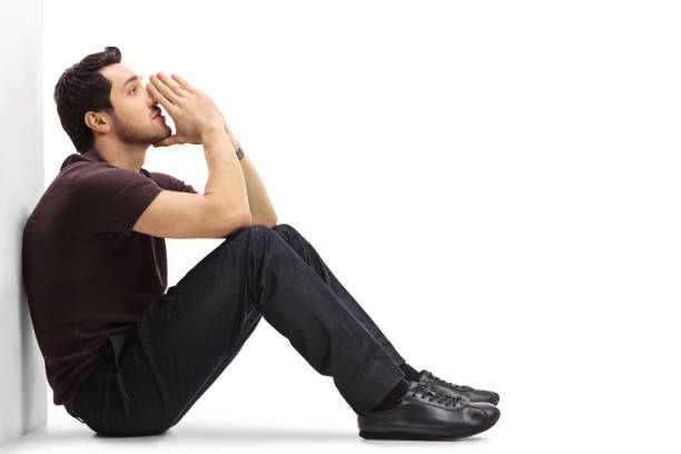 istock Pensive man leaning against a wall and thinking 649749536