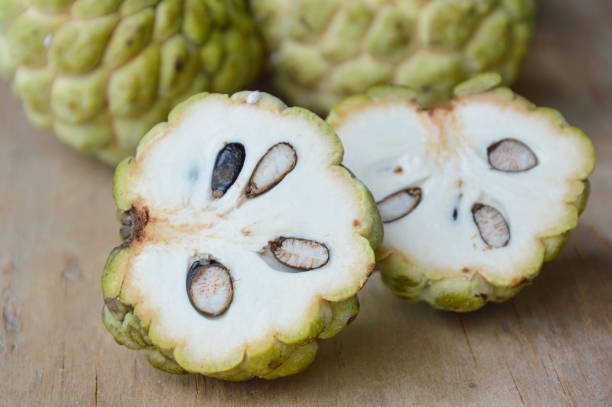 istock sugar apple cut on wooden board 649749910