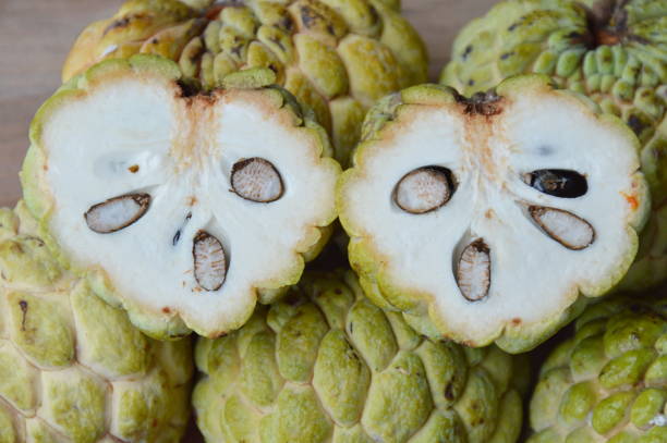 istock custard apple cut on wooden board 649749914