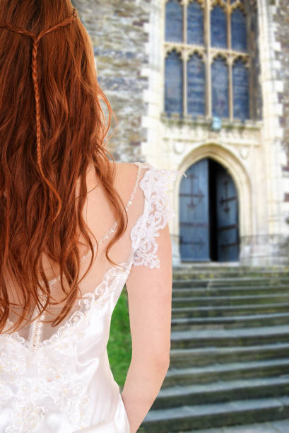 back of bride outside church by stone stairs