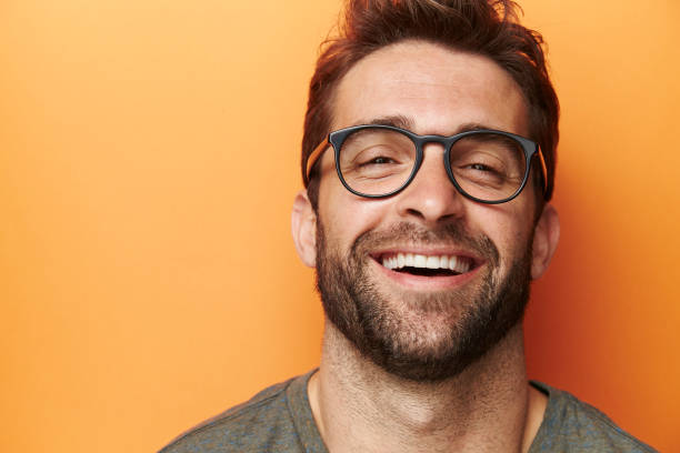 Laughter man Man laughing in orange studio, close up man 30 years old stock pictures, royalty-free photos & images