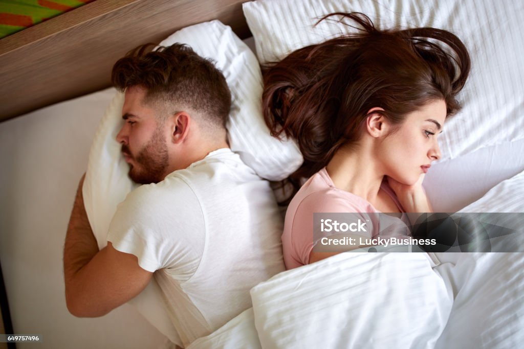 Problems in relationship Couple with problems in relationship in bed Couple - Relationship Stock Photo