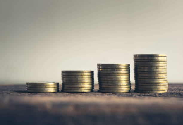 istock Stack of gold coins on cement floor with vintage tone. 649757568