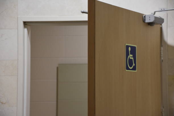 istock Public restroom signs with a disabled access symbol 649760724