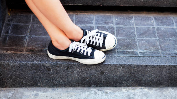 Thai girls legs and canvas shoes, girl standing on steps.