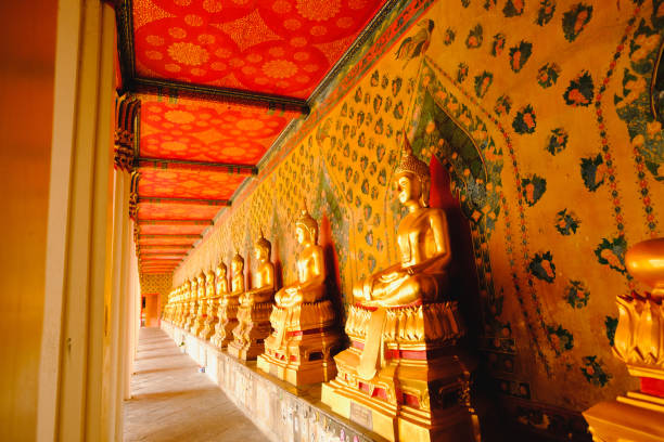 istock Row of Buddha statue in long corridor 649774546