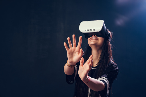 Teenage girl enjoying a VR simulator
