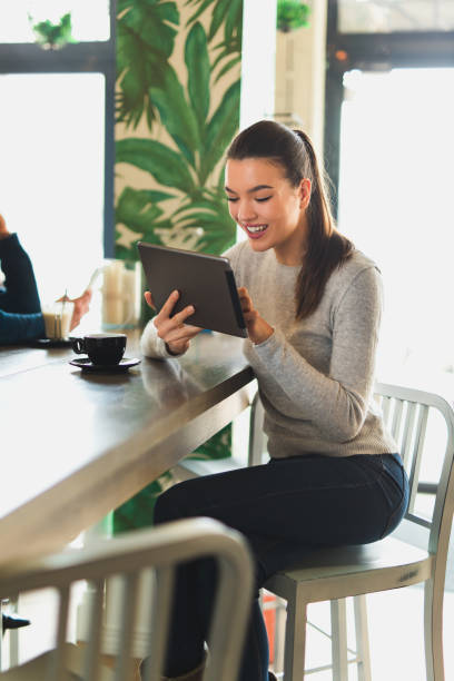 istock Young woman using digital tablet in cafe 649777206
