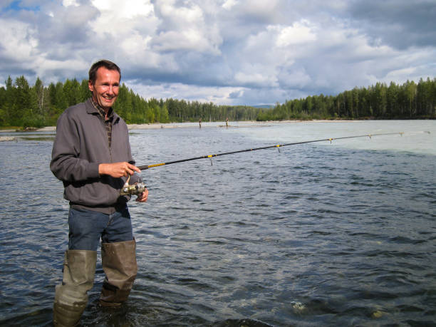 istock Angler fishing for salmon 649777472