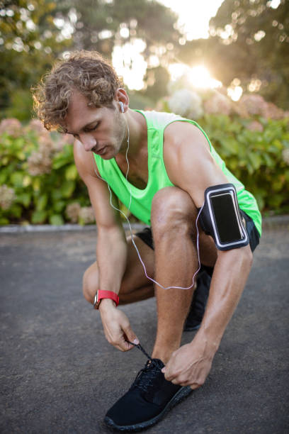 istock Man tying his shoe laces 649777986