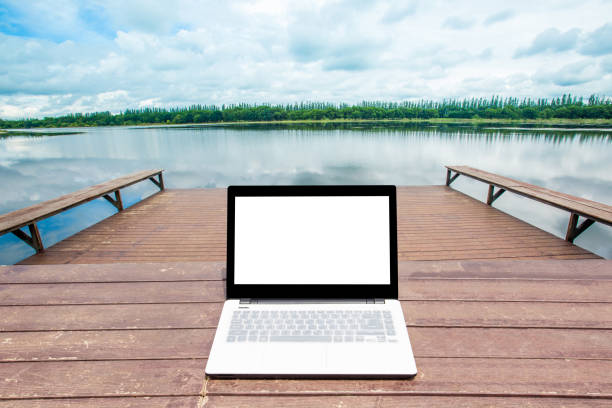 istock laptop over wooden table outdoors 649778438