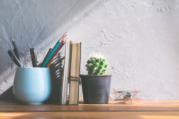istock cactus flower with notebook on office wood table modern interior background concept. 649778792