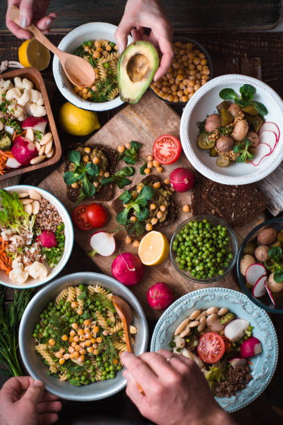 istock Feast with vegetable salads, fruits and sandwiches 649778968